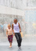 Kids play in a water installation on the Southbank in London, England.
