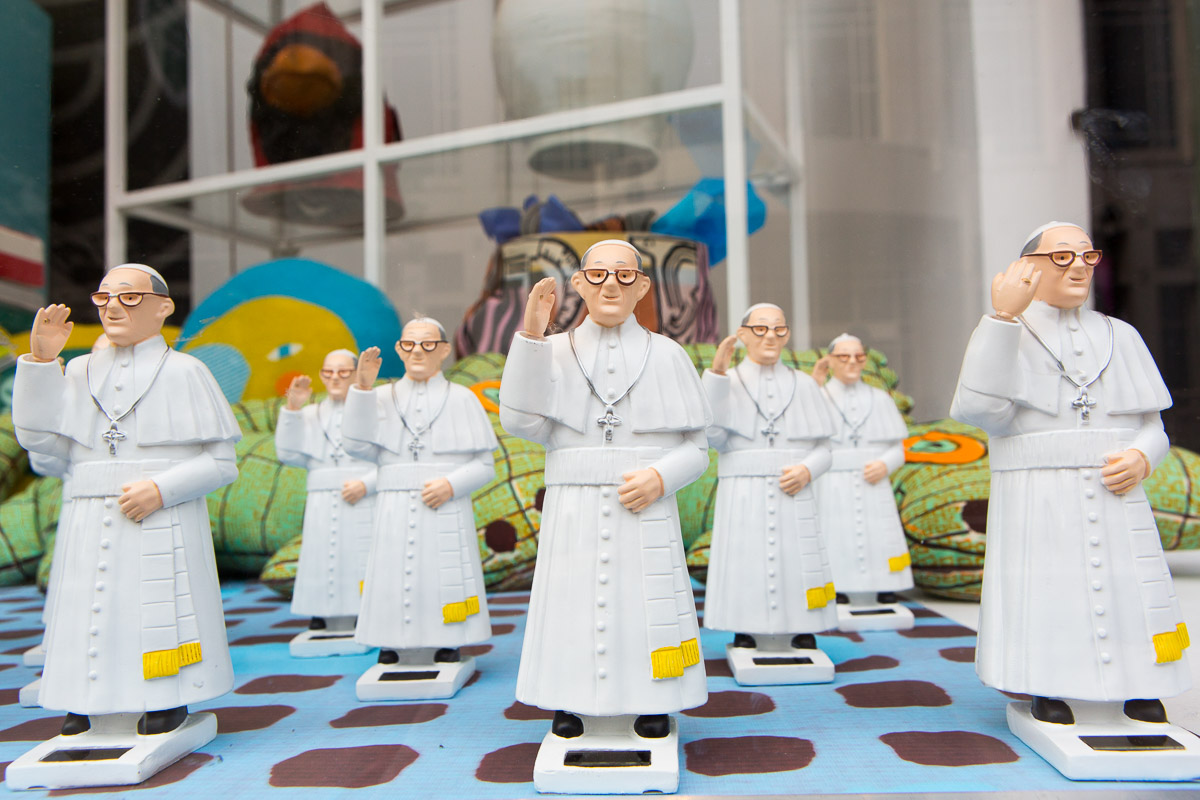 Pope Francis figurines populate a storefront in Philadelphia.