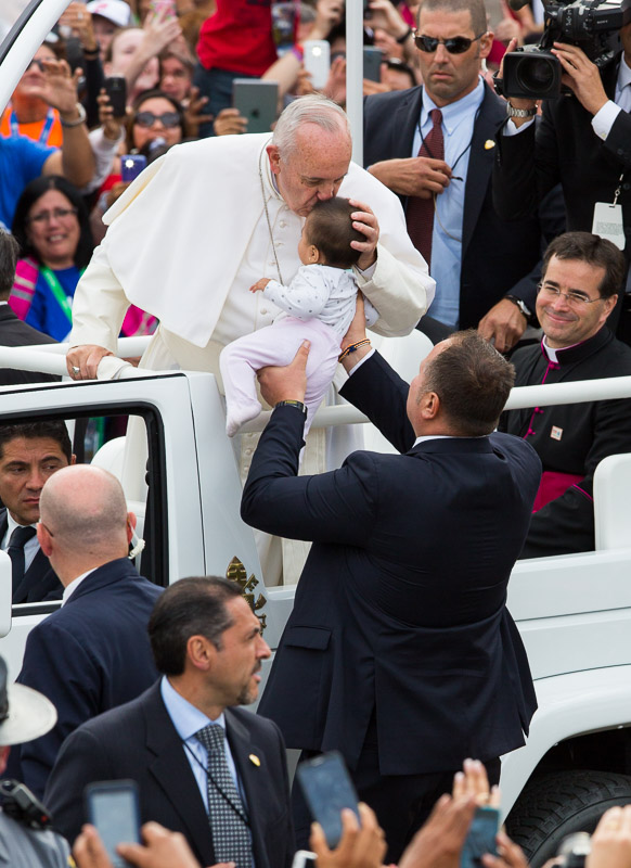 Pope Francis kisses an infant outside Independence Hall in Philadelphia.