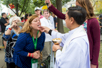 A pilgrim receives communion during mass led by Pope Francis on the Ben Franklin Parkway in Philadelphia.