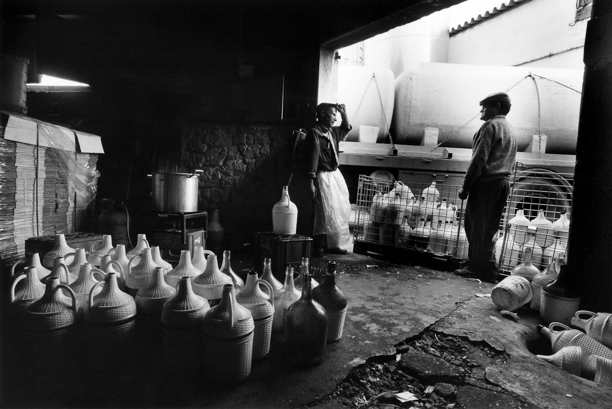 Workers take a break from preparing bottles for bottling wine during vindimas in Portugal.