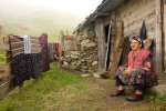 A woman sits on her doorstep in the high plateaus near Uzungöl, Turkey.