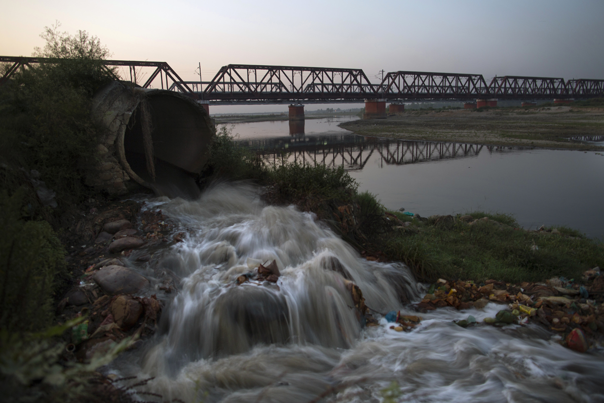 Waste from an open sewar drains in a tributarty of the Ganges river in Moradabad, India.