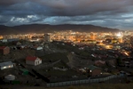 A ger district, bottom, stands near illuminated buildings in Ulaanbaatar, Mongolia.