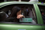 Woman in taxi, Guangzhou.