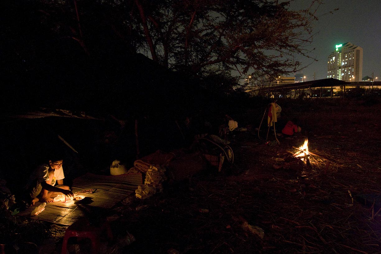 Mahout Jazz sits in front of her tent at a temporary camp near Rama 9 road in Bangkok.