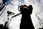 A mahout stands with a chain-saw in an area near Hongsa in Lao PDR.