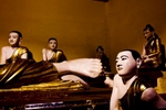 Buddha statues sit in a room at the Shwedagon Pagoda.