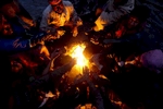 Coal miners huddle around a fire to keep warm in the Jaintia HIlls.