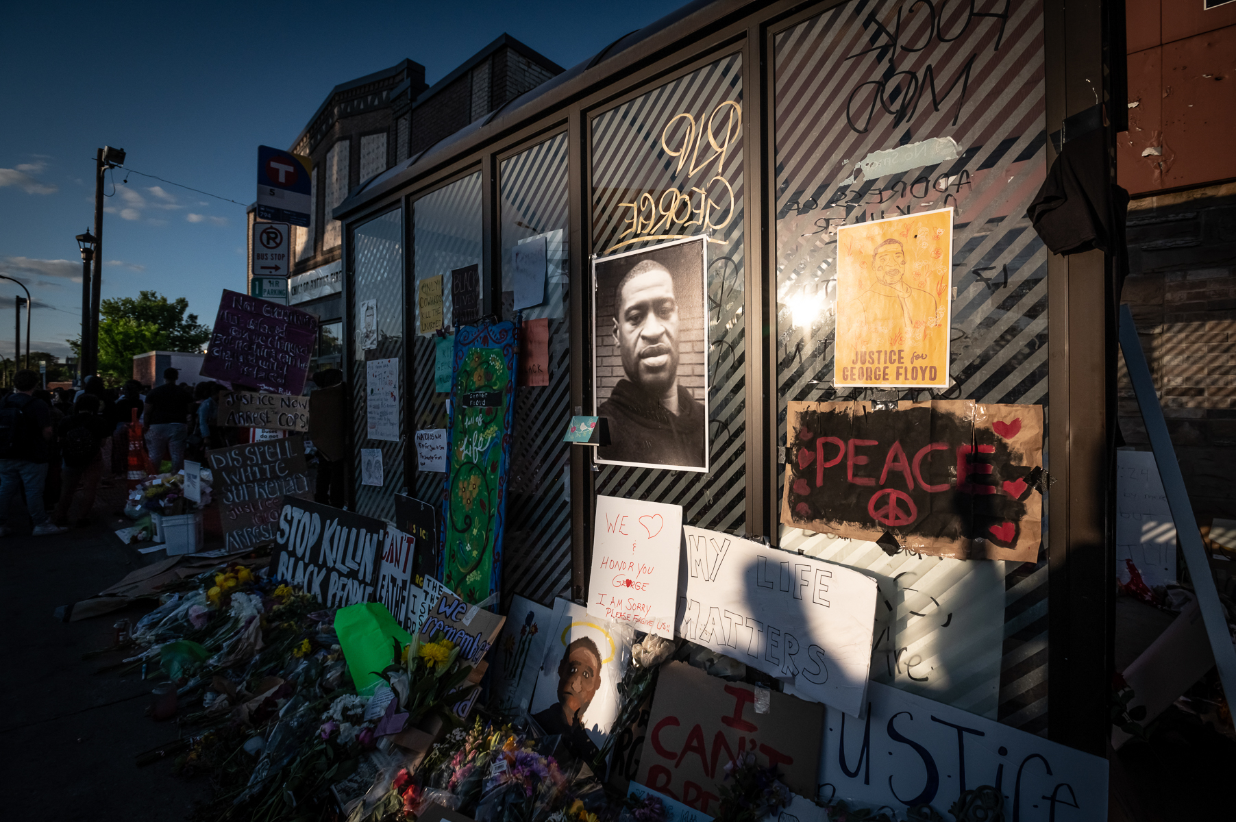 The sun sets as community members continue to gather at East 38th Street and Chicago Avenue, the site where George Floyd was killed by police on Friday, May 29, 2020 in Minneapolis, MN.