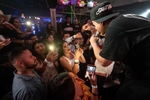 Lead singer Jesus Ortiz Paz of musical group Fuerza Regida greets  fans in the crowd during a live performance in Minneapolis at Eme Antro Bar, a Mexican bar/event space, on July 16, 2021.