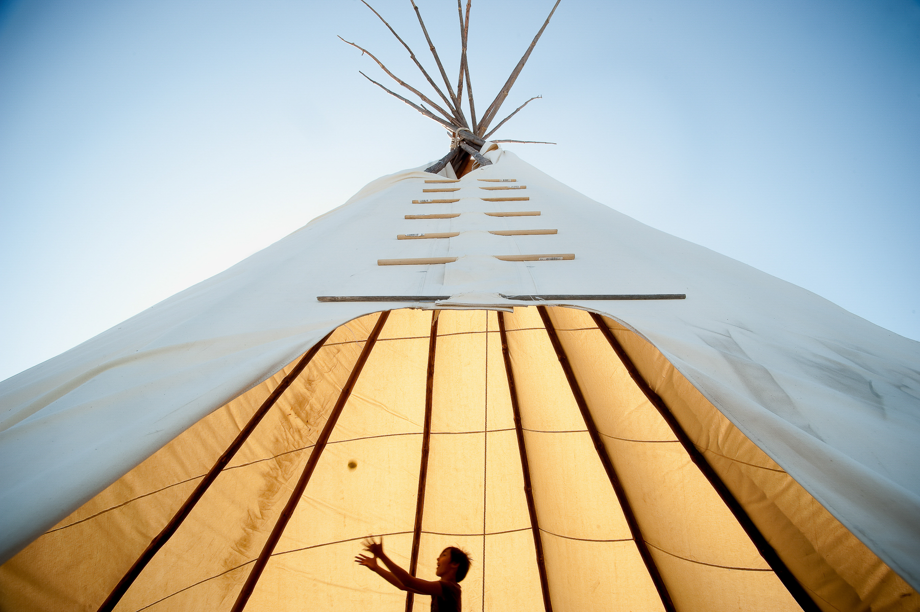Shelby Childs, 9, of Red Wing, Minnesota, played inside a teepee at the Legacy of Survival event in Flandreau, South Dakota on Thursday, August 16, 2012. Held on the 150th anniversary of the beginning of the US-Dakota Conflict of 1862, the three-day event celebrated the resilience of the Dakota people and their culture.