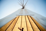 Shelby Childs, 9, of Red Wing, Minnesota, played inside a teepee at the Legacy of Survival event in Flandreau, South Dakota on Thursday, August 16, 2012. Held on the 150th anniversary of the beginning of the US-Dakota Conflict of 1862, the three-day event celebrated the resilience of the Dakota people and their culture.