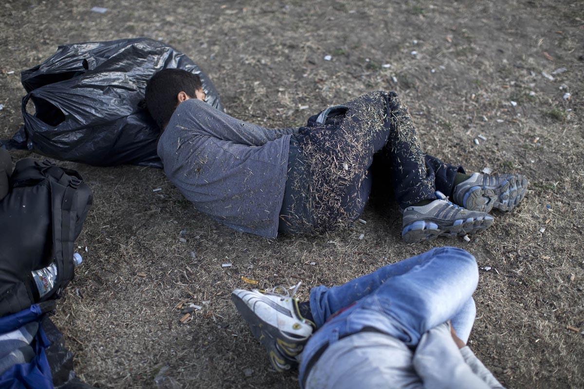 A youth sleeps at a park, Belgrade, Serbia, July 21, 2015. 