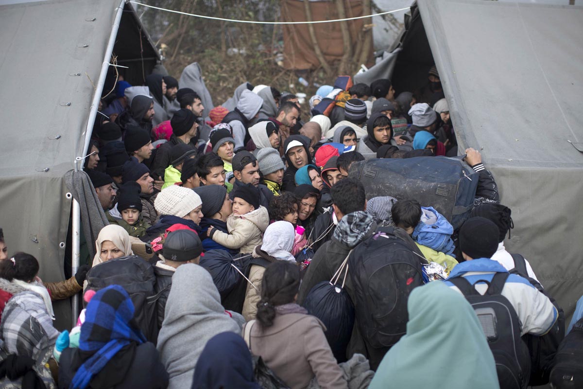 People crowd a tent as they attempt to cross Serbia's border with Croatia, Berkasovo, Serbia, Oct. 24, 2015. 