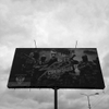 June 12, 2014. A billboard, Artemivsk, Ukraine. On the road to Slovyansk. I eat Kit Kats. M. eats Snickers. A. smokes his pipe. 