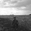 June 14, 2014. A member of a pro-Russian militia stands in a field of wheat, Lugansk, Ukraine. Noone knows where the plane is. Flak jackets on. Something feels strange. I tell A. to drive slowly. We get ambushed by pro-Russians who turn out to be friendly. They take us to the plane. 