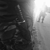 June 18, 2014. Pro-Russian militiamen, Karlovka, Ukraine. We bump into V. downtown, he tells us something is happening in Karlovka. On the way there we stop so A. can buy fish from an old lady by the side of a road in a forest. Alfa Romeo, Lithuanian license plates, gets my attention. A big tall dude in camo gets out, invites us to see an exchange of dead bodies by two sides on the line of separation. BMW, Russian license plates parks next to A.'s minivan. A guy in a balaclava gets out, takes an armed RPG launcher out of the trunk, casually leans it on the side of the car. Flak jackets on. 