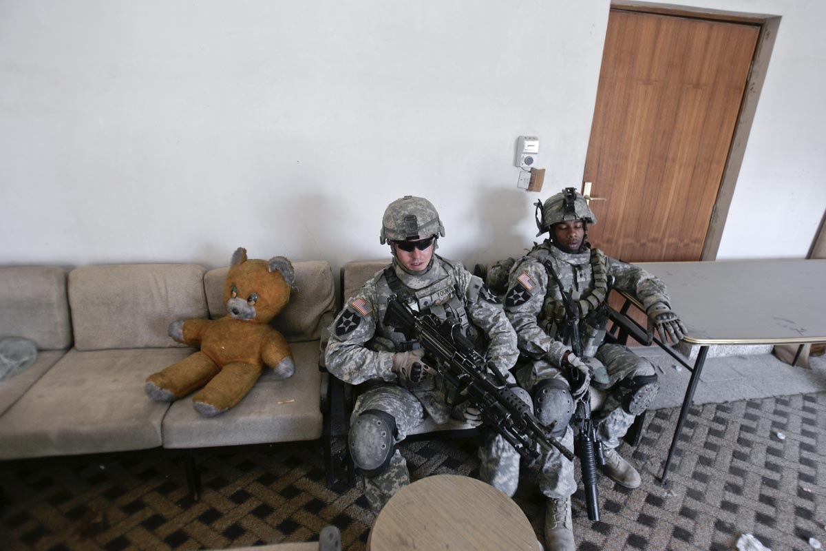 U.S. army soldiers from Blackhawk Company, 1st Battalion, 23rd Infantry Regiment, take a break in a house after a foot patrol, Baghdad, Iraq, 2007.