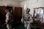 A U.S. army soldier from Blackhawk Company, 1st Battalion, 23rd Infantry Regiment, admires a sword he found while searching a home, Baghdad, Iraq, 2007.
