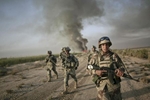 An Iraqi army soldier conducts a foot patrol together with U.S. army soldiers from Fox Troop, Sabre Squadron, 3rd Armored Cavalry Regiment, after they set a deserted village on fire, Diyala province, Iraq, 2008.