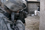 A U.S. army soldier from Blackfoot Company, 2nd Battalion, 23rd Infantry Regiment storms a back yard of a house during an offensive, Muqdadiyah, Iraq, 2007.