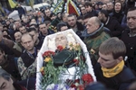 People carry a coffin of a man killed in clashes, Kiev, Ukraine, Feb. 21, 2014. 