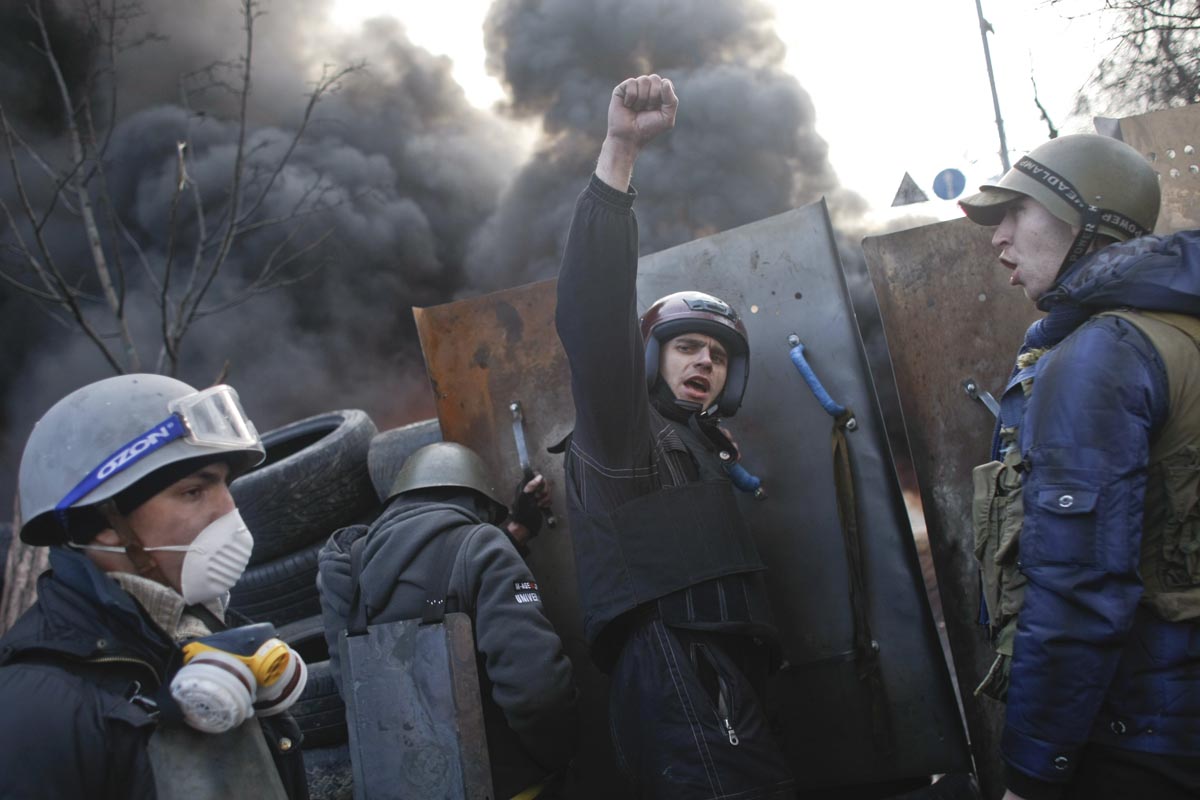 Protesters chant slogans as they man a barricade, Kiev, Ukraine, Feb. 21, 2014. 