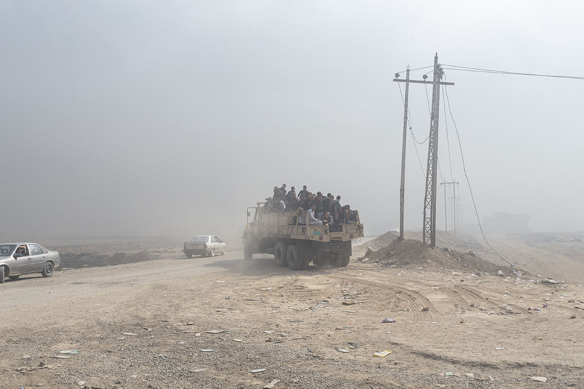 A truck carries people fleeing from conflict, Qayara, south of Mosul, Iraq, Oct. 26, 2016.