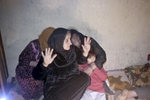 Women are startled as their family member is detained by U.S. army soldiers from Blackfoot Company, 2nd Battalion, 23rd Infantry Regiment, during a night raid, Diyala province, Iraq, 2007.