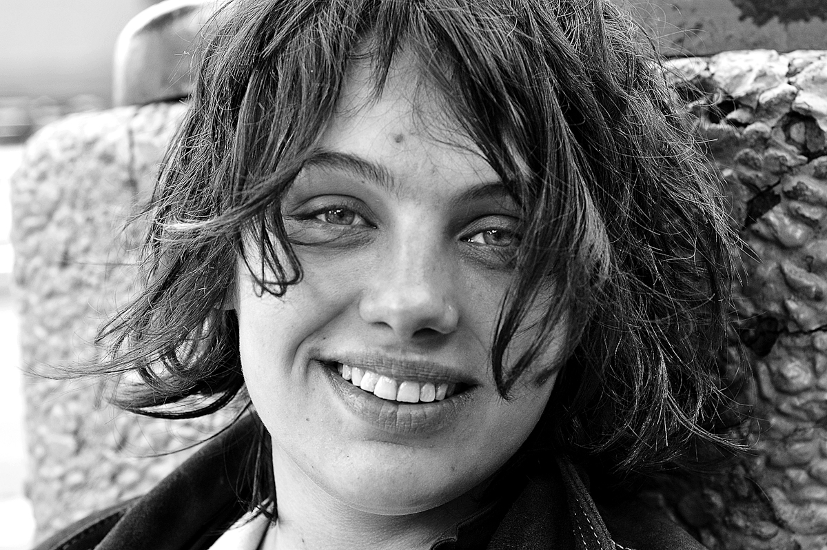HOMELESS GIRL, SAN FRANCISCO, APRIL 2006homeless leilana sitting against trash can on sidewalk. she had just been in a fight so her eyes are swollen. sleeps in the park, which she's done since coming to sf 8 years ago. she got here by hitching from east coast; doing {quote}whatever{quote} to make a buck along the way.she has a few raw sores on her face mostly hidden by her hair. i've seen her around for a while now, usually sitting huddled somewhere staring at nothing. i worried she might have some mental / emotional problems from how she acted, but talking to her, she seems fine.but she's clearly weary and has moments where the thoughts and memories going through her head seem to chill her thoroughly.she says she's trying to take a vacation from fucking herself up.(4/3/06)