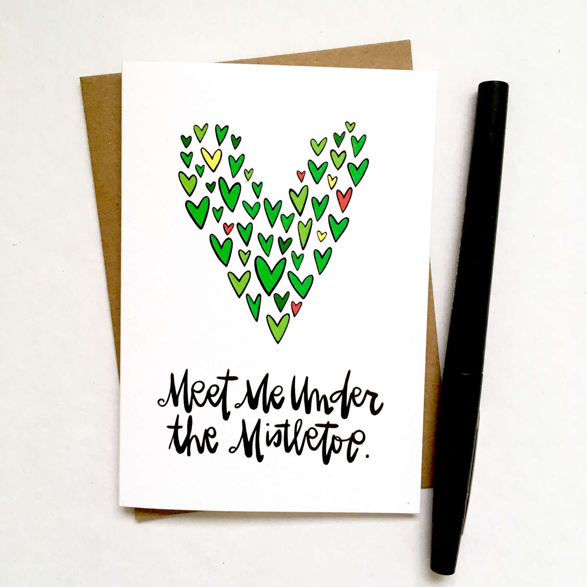 purchase herewho are you hoping to meet under the mistletoe?? // this brand new super cute holiday card is the perfect way to snag that kiss, yo // get yours while they're still in stock!each card is:printed on 100# recycled + responsibly-sourced paper //measuring 3.5{quote} x 5{quote} //accompanied by a recycled kraft paper 4-bar envelope //professionally printed on a digital press //individually packaged in sealed cellophane sleeve //made with mad love in colorado, usa. 