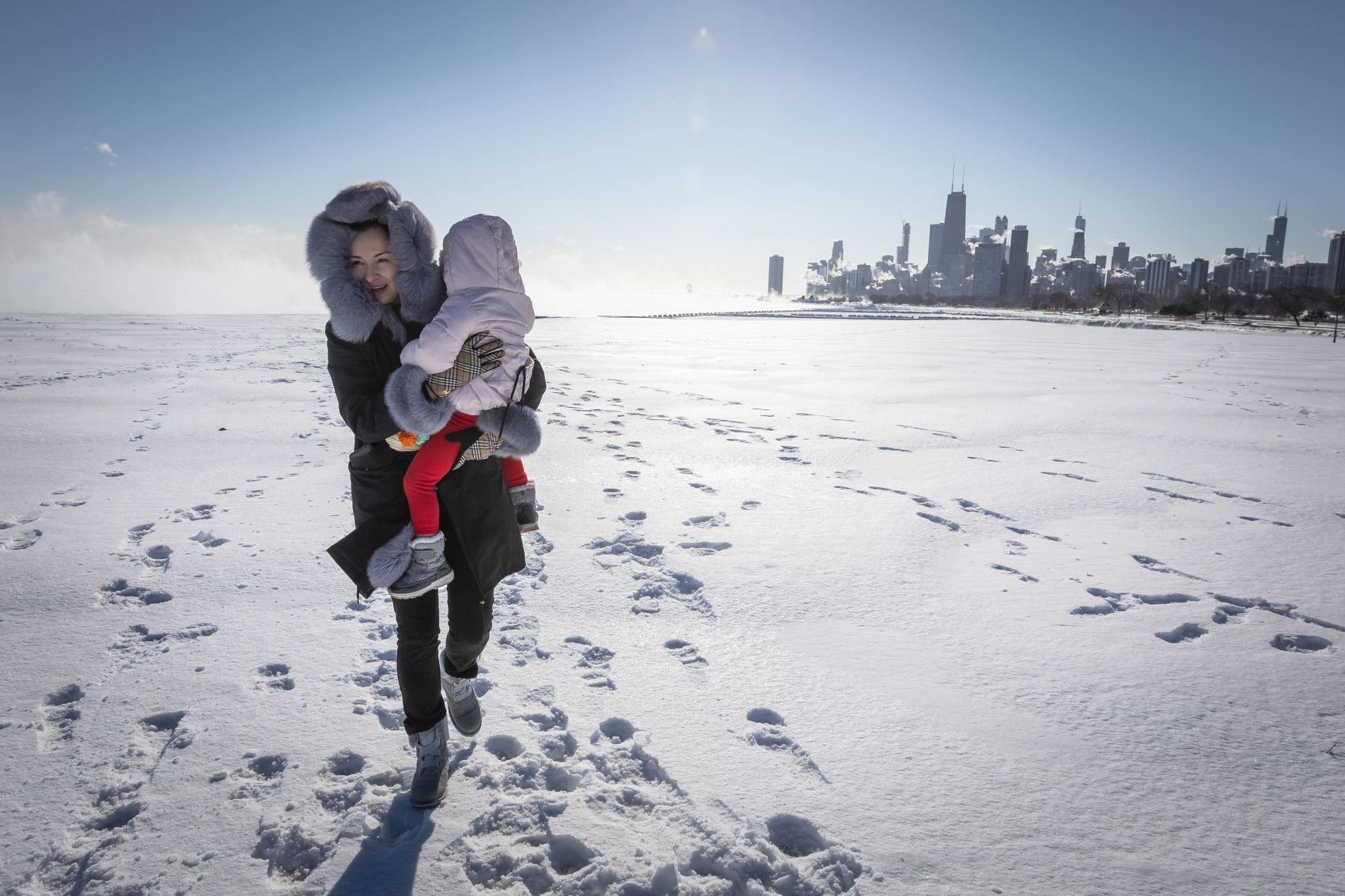 Chicago residents visit the Lakefront of Lake Michigan during the polar vortex on Jan, 30, 2019. Wednesday marks the coldest day in Chicago history. From the crackling Lakefront to the city’s El stops, locals took on the record breaking wind chills. The polar vortex that brought the Chicago area to a halt in January will now be remembered as producing the state’s coldest temperature ever, according to weather officials. Manuel Martinez/WBEZ
