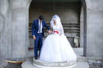 A Georgian-Azeri couple, who are Muslim, pose in front of a mosque on their wedding day. They met one month earlier, the day their engagement was announced. She is 17 and he is 22.