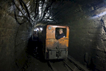 Georgia, Chiatura City. Miners in a mining train on their way to the tunnel in 40 km depth. Miners work 12 hours everyday with a monthly salary of approximately $150 - 300.
