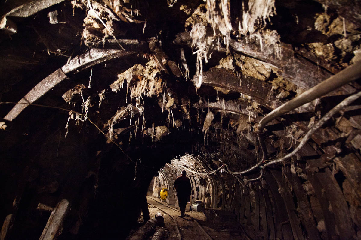 Georgia, Chiatura City. A miner walks through a manganese mine tunnel.