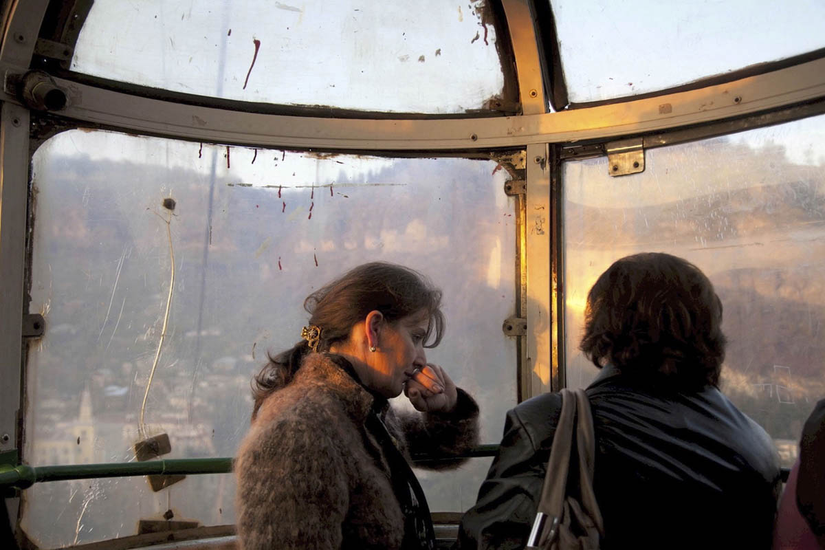 Georgia. Chiatura City.  Women riding home. Cable cars are dated back at Soviet era. It was build to tranport mineworkers up and down the mines.  60 years later it is still running and used as public transportation. 