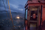 Georgia, Chiatura City. A cable car system dating back to the 1950s runs along the city's vast gorges. The cars were used to transport miners but today they are also used as public transportation for the locals. Here, a cable car controller works the night shift.