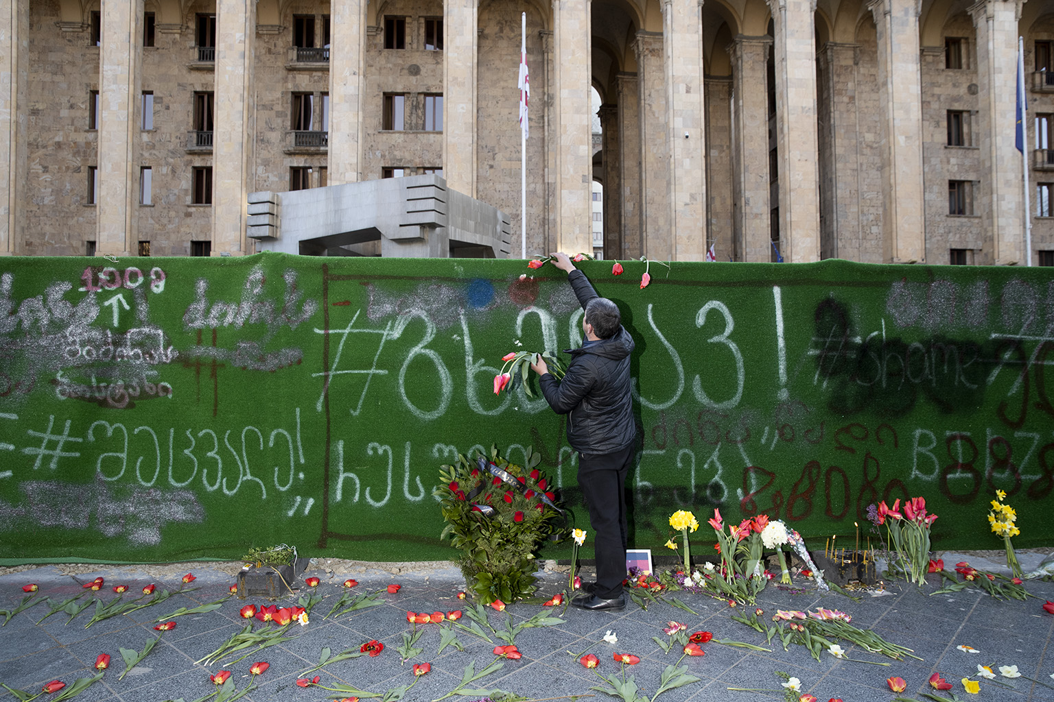 In front of the parliament. A local Georgian with flowers paying tribute to the 21 victims of the April 9 tragedy. My mom and dad were also present during the anti-soviet demonstration 31 years ago. Memorial looks sad during the crisis, but few people still came with masks. 