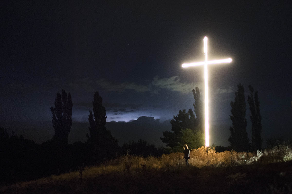 2017. Georgia, a brightly lit cross, erected after the 2008 Russo-Georgian War, stands on the road leading to the village of Dvani. During the conflict, up to 50 houses were burned down and bombed.