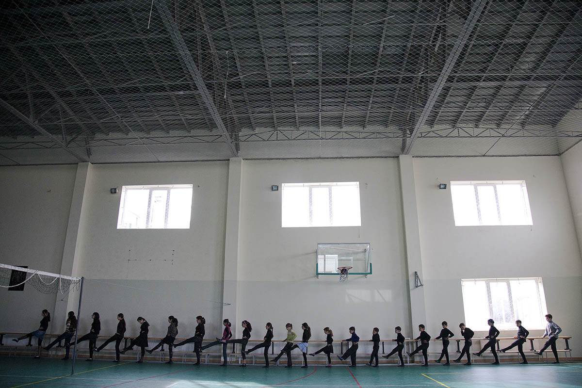 2010.  Georgia, Students practice traditional folk dancing at a school gym in Tserovani.