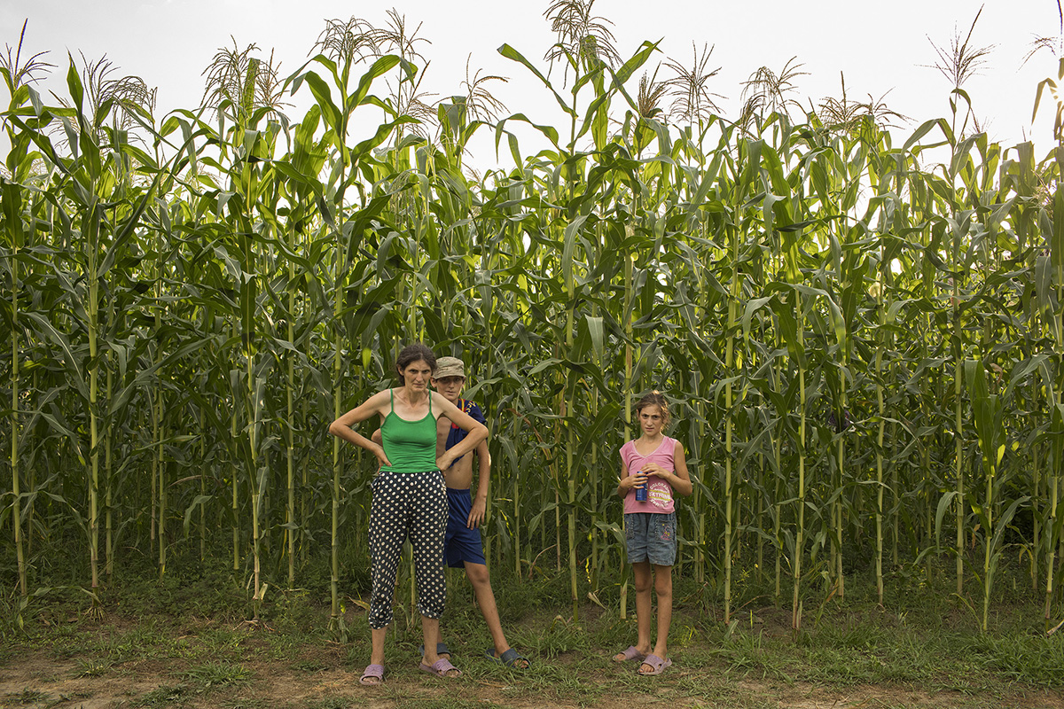 A family stands near their corn field in Pakhulani village in Georgian in 2017.