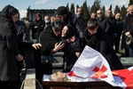 The family of volunteer fighter Davit Ratiani, who was killed in Ukraine, mourns over his open casket on March 26, 2022 in Tbilisi, Georgia. Davit Ratiani, 53 years old, died under artillery fire on March 18th, while saving a wounded volunteer French fighter in the Irpin front, northwest of Kyiv. For many Georgians, the war in Ukraine amounts to a continuation of their ongoing struggle  with Russia.At least 35 Georgians have died fighting in Ukraine since the beginning of the war, which is likely the largest death toll among any foreign contingent fighting on the Ukrainian side.