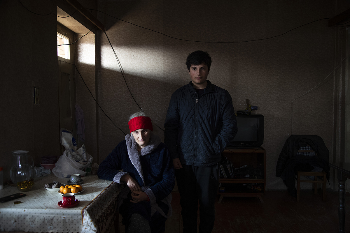 Dato Tsertsvadze, 14 years old, with his mother at their home  in Zeghduleti village, Georgia on January 15, 2023. Data is the grandson of Valia Valishvili, a women stranded in her home that was fenced in the Russian controlled territory in South Ossetia region. 