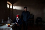 Dato Tsertsvadze, 14 years old, with his mother at their home  in Zeghduleti village, Georgia on January 15, 2023. Data is the grandson of Valia Valishvili, a women stranded in her home that was fenced in the Russian controlled territory in South Ossetia region. 