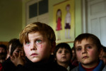 GEORGIA. Pankisi Gorge, a Chechen refugee settlement. January. 2008. Kindergarten. A boy with green eyes, Omaar, 7 years old. Omaar's family was bombed during the Chechen war while he was just a baby. He was left with his grandmother, who survived the bombing.