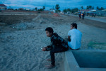Construction workers are relaxing after a day’s work at the New World mega housing project on the outskirts of Phnom Penh. They are mostly from the countryside and earn anywhere between five to ten dollars per day depending on their skills. December 2011