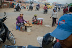 Construction workers shopping for dinner on the way home to their communal dwelling at the New World mega housing project on the outskirts of Phnom Penh. They are mostly from the countryside and earn anywhere between five to ten dollars per day depending on their skills. December 2011