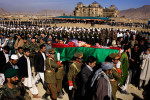Rows of Afghan dignitaries, military, police and mourners pay last respects to six parliamentarians including opposition leader Mustafa Kazimi, during a state funeral near the Darulaman Palace, in background, in Kabul, Afghanistan on Thursday November 8, 2007. The lawmakers and six of their bodyguards, who were also killed in the attack, were buried together in a place of honor near the location of a planned new parliament building. Thousands attended the official ceremony during the second of three national days of mourning for the 52 killed in a suicide attack in Baghlan province on Tuesday, November 6, 2007.   