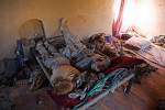 Sergeant Bryan Hulit, right, reads while fellow soldiers get some sleep on an Afghan bed they found in the compound they took over during their clearing operations in the village of Talukan. The 1st Battalion, 187th Infantry Regiment, Third Brigade Combat Team, of the 101st Airborne Division started to clear the roads and houses of the village of Talukan in Pajwai district of Kandahar. The soldiers have found as many as 9 Improvised Explosive Devices all around the main market and roads leading into the village.